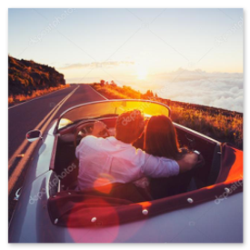 Convertible driving over a dramatic alpine pass