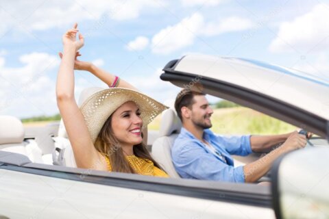 Couple in a Mercedes SLK on a scenic Swiss alpine road